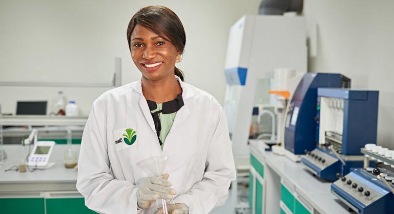 A female cocoa employee in an innovation laboratory, Olam.